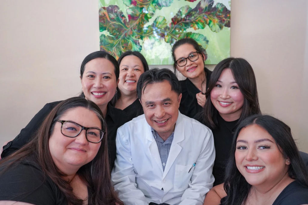 Dr. Thuc Luu, DMD, and the Fairview Dental team standing together in their dental office.